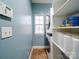 Well-organized laundry room with a side-by-side washer and dryer, shelving, and a window at 2538 Cherry Bark Oak Ct, Gastonia, NC 28056