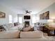 Bright living room with fireplace, ceiling fan, and comfortable sofas, perfect for relaxation at 2538 Cherry Bark Oak Ct, Gastonia, NC 28056