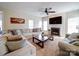 Comfortable living room with fireplace, fan, and ample seating at 2538 Cherry Bark Oak Ct, Gastonia, NC 28056