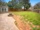 This backyard features a fire pit, storage building, new fence and green grass at 2927 Clemson Ave, Charlotte, NC 28205