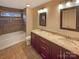 This bathroom features a double sink vanity, granite counters, modern lighting and a shower over tub at 2927 Clemson Ave, Charlotte, NC 28205