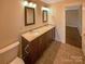 This bathroom features a double sink vanity, granite counters, modern lighting and tiled floors at 2927 Clemson Ave, Charlotte, NC 28205