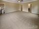 Large bedroom features plush carpeting, ample natural light, and a ceiling fan at 2927 Clemson Ave, Charlotte, NC 28205