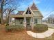 Charming home with a unique roofline, covered porch, and manicured landscaping at 2927 Clemson Ave, Charlotte, NC 28205