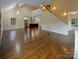 Bright living area features an open concept layout, hardwood flooring, and a staircase at 2927 Clemson Ave, Charlotte, NC 28205