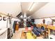Unfinished attic space with wood framing, carpeting, old furniture and a single window at 30 Hillsboro Rd, Taylorsville, NC 28681