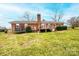 Expansive backyard featuring a deck, trampoline, and lush green lawn, providing a perfect outdoor space for activities at 30 Hillsboro Rd, Taylorsville, NC 28681