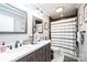 Stylish bathroom featuring a double sink vanity with modern fixtures and a contrasting dark tile accent wall at 30 Hillsboro Rd, Taylorsville, NC 28681