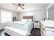 Inviting bedroom with wood-look floors, ceiling fan, and light gray walls and white trim at 30 Hillsboro Rd, Taylorsville, NC 28681