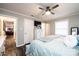 Inviting bedroom with wood-look floors, ceiling fan, and light gray walls with bright trim at 30 Hillsboro Rd, Taylorsville, NC 28681