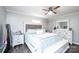 Inviting bedroom with wood-look floors, ceiling fan, and light gray walls and white trim at 30 Hillsboro Rd, Taylorsville, NC 28681