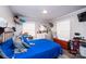 Comfortable bedroom with natural light, wall-mounted TV, and closet space at 30 Hillsboro Rd, Taylorsville, NC 28681