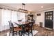 Dining area with modern hanging light fixture, and view to the entryway and dining room hutch at 30 Hillsboro Rd, Taylorsville, NC 28681