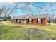 Charming single-story brick home with a welcoming porch and well-maintained lawn at 30 Hillsboro Rd, Taylorsville, NC 28681