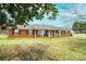 Charming single-story brick home with a welcoming porch and well-maintained lawn at 30 Hillsboro Rd, Taylorsville, NC 28681