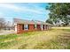 Side view of a brick home with an attached garage and covered front porch at 30 Hillsboro Rd, Taylorsville, NC 28681
