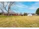 Sprawling red brick ranch home with inviting front porch, spacious lawn and detached garage at 30 Hillsboro Rd, Taylorsville, NC 28681