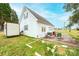 Detached garage with white siding, double doors, and a compact storage shed at 30 Hillsboro Rd, Taylorsville, NC 28681