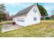 Detached garage with a clean white exterior and ample parking space at 30 Hillsboro Rd, Taylorsville, NC 28681