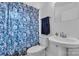 Cozy bathroom with shower/tub combination, pedestal sink, and neutral decor at 3036 Marlowe Ave, Charlotte, NC 28208