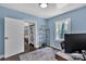 Bedroom featuring blue walls, hardwood flooring, natural light, with an open door to a closet at 3036 Marlowe Ave, Charlotte, NC 28208