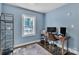 Bedroom with blue walls, hardwood flooring, natural light, shelf, desk and monitor at 3036 Marlowe Ave, Charlotte, NC 28208