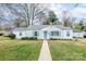 Charming single story home with walkway, blue shutters, neutral paint and lush front yard at 3036 Marlowe Ave, Charlotte, NC 28208