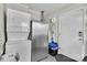 Utility room features a washer, dryer and stainless steel refrigerator with a neutral painted walls and concrete floor at 3036 Marlowe Ave, Charlotte, NC 28208