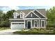 Charming new construction featuring a two-car garage, neutral-colored exterior, and well-maintained landscaping at 333 Basil Dr, Indian Trail, NC 28079