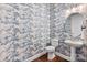 Charming powder room featuring unique wallpaper and a pedestal sink at 333 Basil Dr, Indian Trail, NC 28079