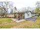Lush backyard featuring a covered deck, a well-maintained lawn, and mature trees at 3901 Durham Ln, Charlotte, NC 28269