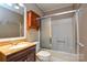 Traditional bathroom with a bath/shower combination and vanity with cherry wood finish at 3901 Durham Ln, Charlotte, NC 28269