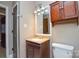 Bathroom featuring a vanity cabinet with a marble countertop and decorative cherry wood cabinet at 3901 Durham Ln, Charlotte, NC 28269