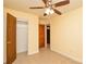 A clean bedroom features tile flooring, a ceiling fan, and a spacious closet, providing a simple and comfortable retreat at 3901 Durham Ln, Charlotte, NC 28269