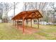 Backyard featuring a covered carport structure and multiple storage sheds at 3901 Durham Ln, Charlotte, NC 28269