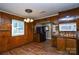 The dining room features wood paneling and flooring, complemented by a chandelier, creating a vintage and inviting atmosphere at 3901 Durham Ln, Charlotte, NC 28269