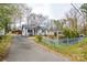 Exterior shot of a quaint home with a long driveway leading to a covered carport and shed at 3901 Durham Ln, Charlotte, NC 28269