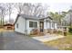 Cozy single-story home with a covered carport and shed visible along the paved driveway at 3901 Durham Ln, Charlotte, NC 28269