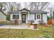 Charming single-story home featuring stone-accented porch columns and beautifully landscaped front yard at 3901 Durham Ln, Charlotte, NC 28269