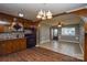 The kitchen opens into a dining area with classic wood cabinets and appliances, connecting cooking and dining spaces at 3901 Durham Ln, Charlotte, NC 28269