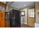 The kitchen features black appliances, wood paneling, and a door to the outside, blending utility with vintage design at 3901 Durham Ln, Charlotte, NC 28269