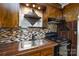 An upgraded kitchen displays mosaic backsplash, a stainless sink, and unique wood countertops, combining functionality and style at 3901 Durham Ln, Charlotte, NC 28269