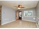 Bright living room with tile flooring, ceiling fan, and a large window offering natural light at 3901 Durham Ln, Charlotte, NC 28269