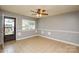 Inviting living room featuring tile floors, a ceiling fan, and a window with backyard views at 3901 Durham Ln, Charlotte, NC 28269