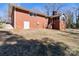 View of the house from the backyard, showing back door entrance and stairs at 407 Pinecroft Ln, Spencer, NC 28159