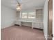 Bedroom with built-in desk area, carpet flooring, and natural light at 407 Pinecroft Ln, Spencer, NC 28159
