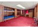 Bedroom featuring built-in bunk beds, ladder, desk, and dresser for a functional living space at 407 Pinecroft Ln, Spencer, NC 28159