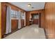 Dining room with wood paneling, tile floor, and natural light at 407 Pinecroft Ln, Spencer, NC 28159