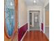 Inviting foyer with hardwood floors, a decorative glass front door, and wainscoting at 407 Pinecroft Ln, Spencer, NC 28159