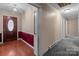 Inviting foyer with hardwood floors, a decorative glass front door, and wainscoting at 407 Pinecroft Ln, Spencer, NC 28159